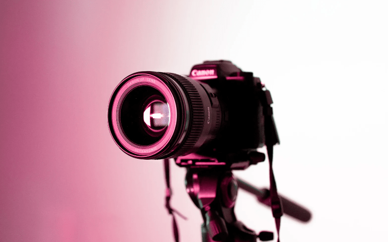 Professional video camera with lens and viewfinder, used for capturing high-quality video footage